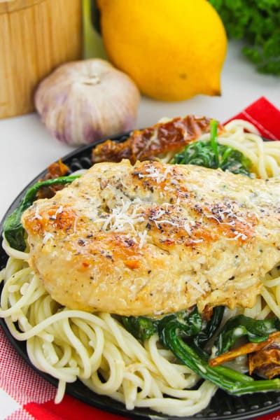 plate of Tuscan chicken on top of noodles