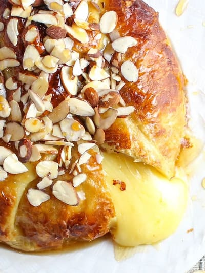 plate of baked brie with honey and almonds