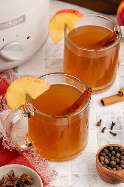 two glasses of spiked apple cider