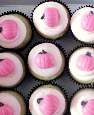 tray of pink pumpkin cupcakes