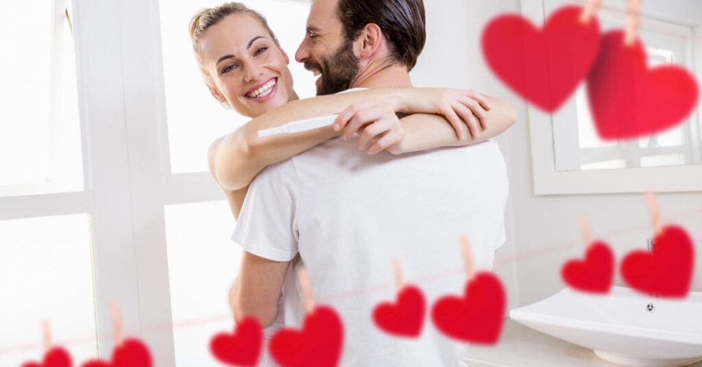 main image of Valentine's baby announcement ideas: man hugging woman holding a pregnancy test