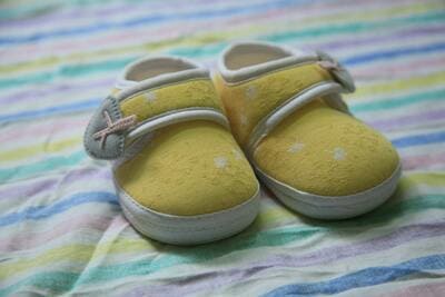 baby shoes on a rainbow pastel blanket