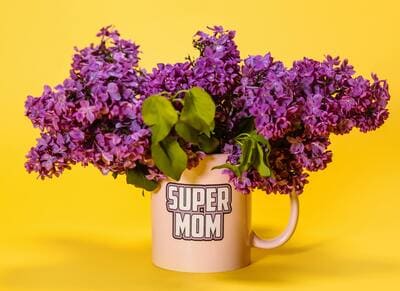 bouquet of flowers in a Super Mom coffee cug