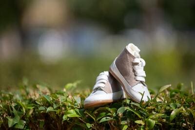 pair of baby shoes in the grass