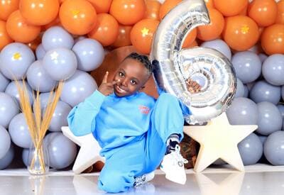 birthday boy with #6 balloon