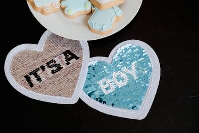 baby shower cookies with a sign saying "it's a boy"